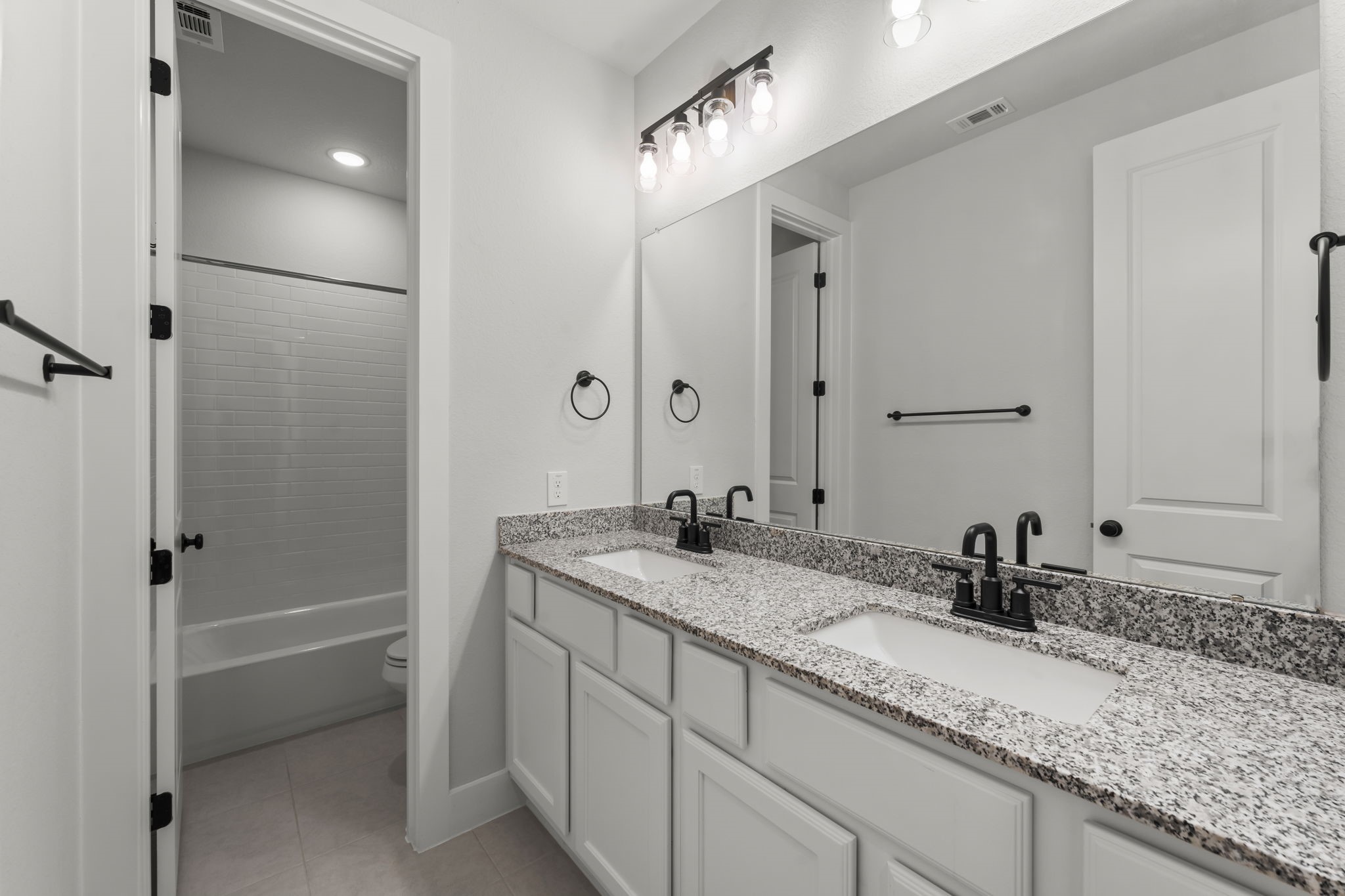 17151 Sandstone Street Conroe, TX 77302 - Photo 29 of 38 a bathroom with a sink and a mirror
