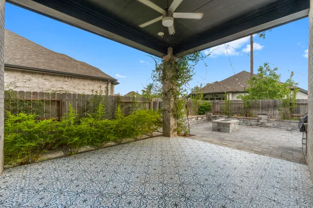 a view of a patio with table and chairs under an umbrella