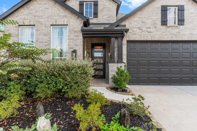 a front view of a house with potted plants