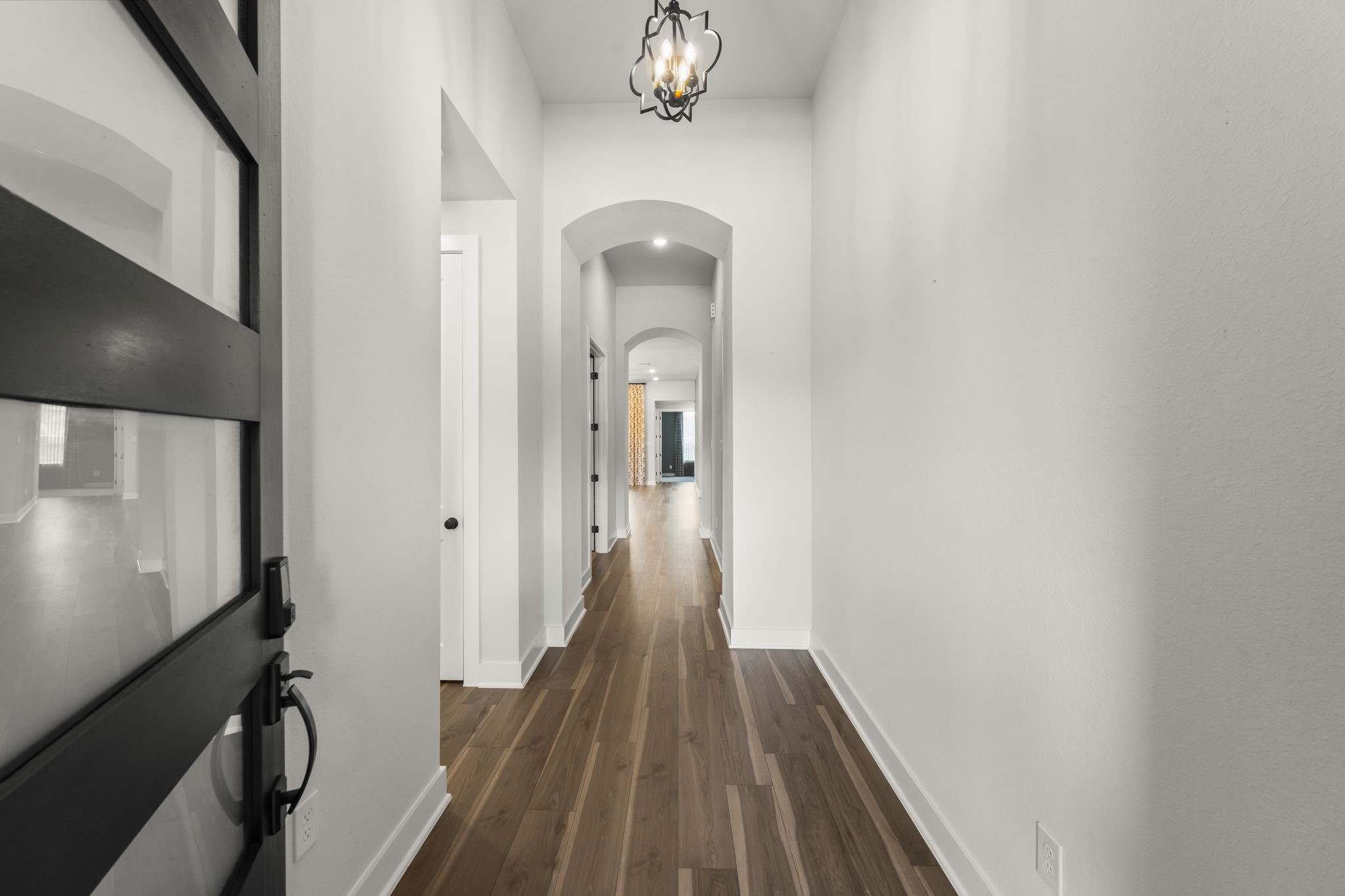 17151 Sandstone Street Conroe, TX 77302 - Photo 5 of 38 a view of a hallway with wooden floor and staircase