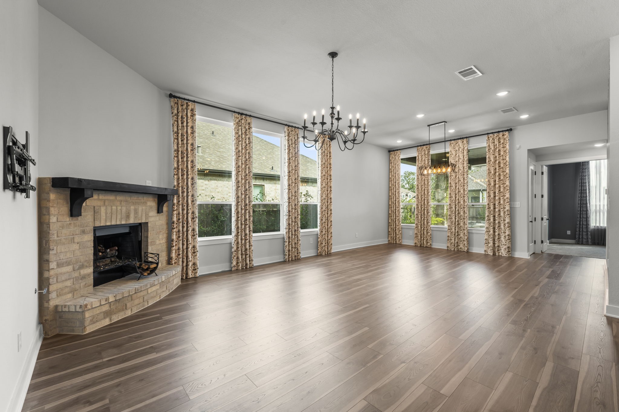 17151 Sandstone Street Conroe, TX 77302 - Photo 6 of 38 a view of an empty room with wooden floor fireplace and a window