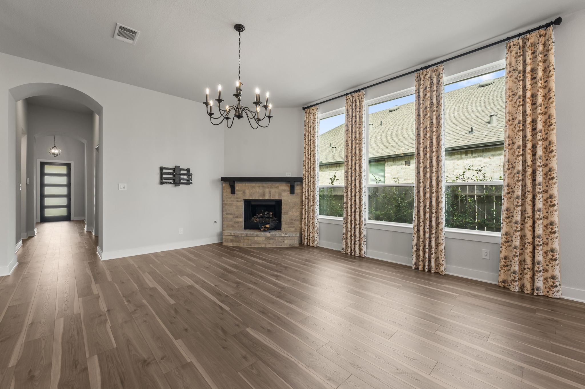 17151 Sandstone Street Conroe, TX 77302 - Photo 9 of 38 a view of an empty room with wooden floor and a window