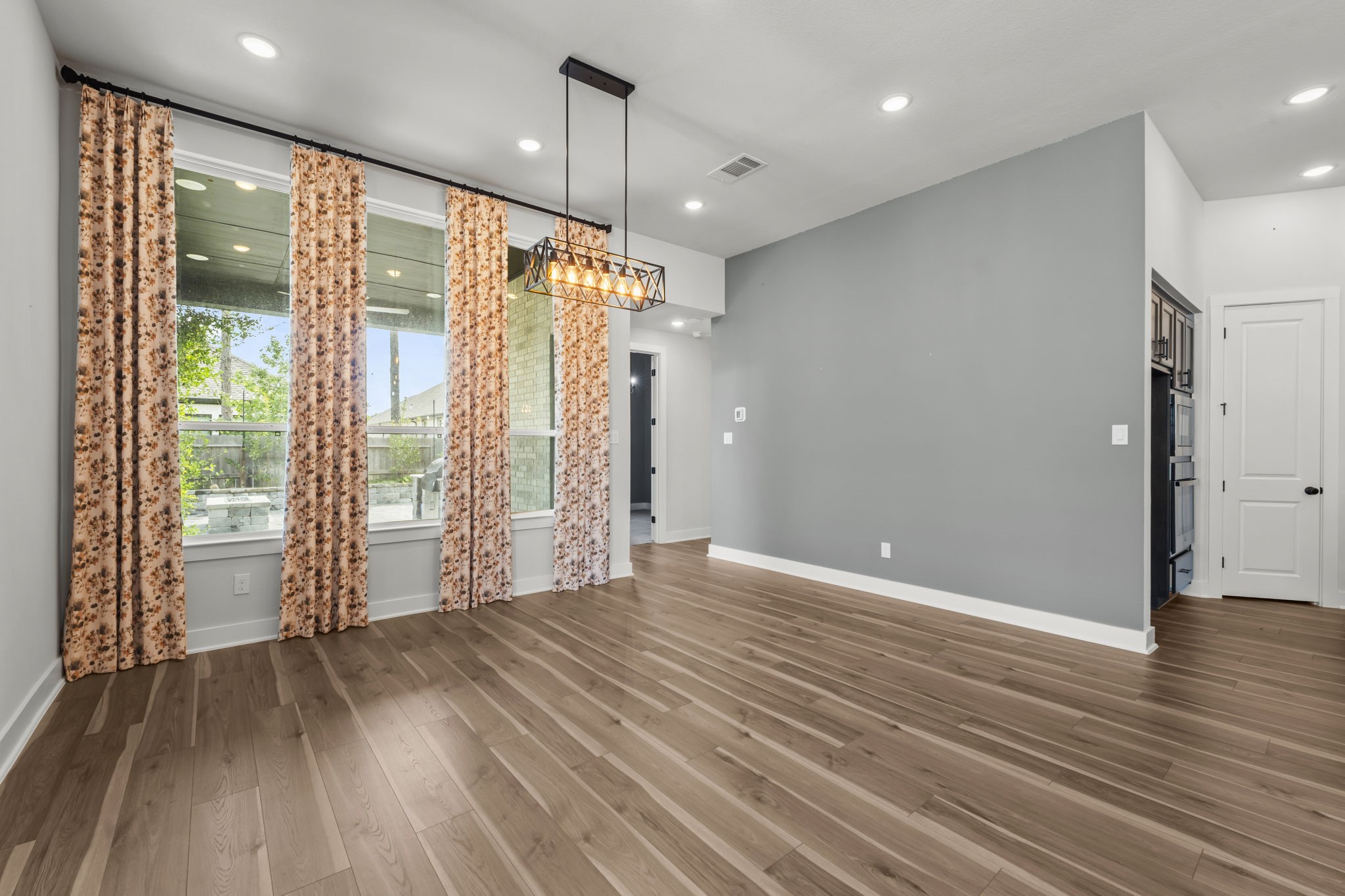 17151 Sandstone Street Conroe, TX 77302 - Photo 10 of 38 a view of an empty room with wooden floor and a window