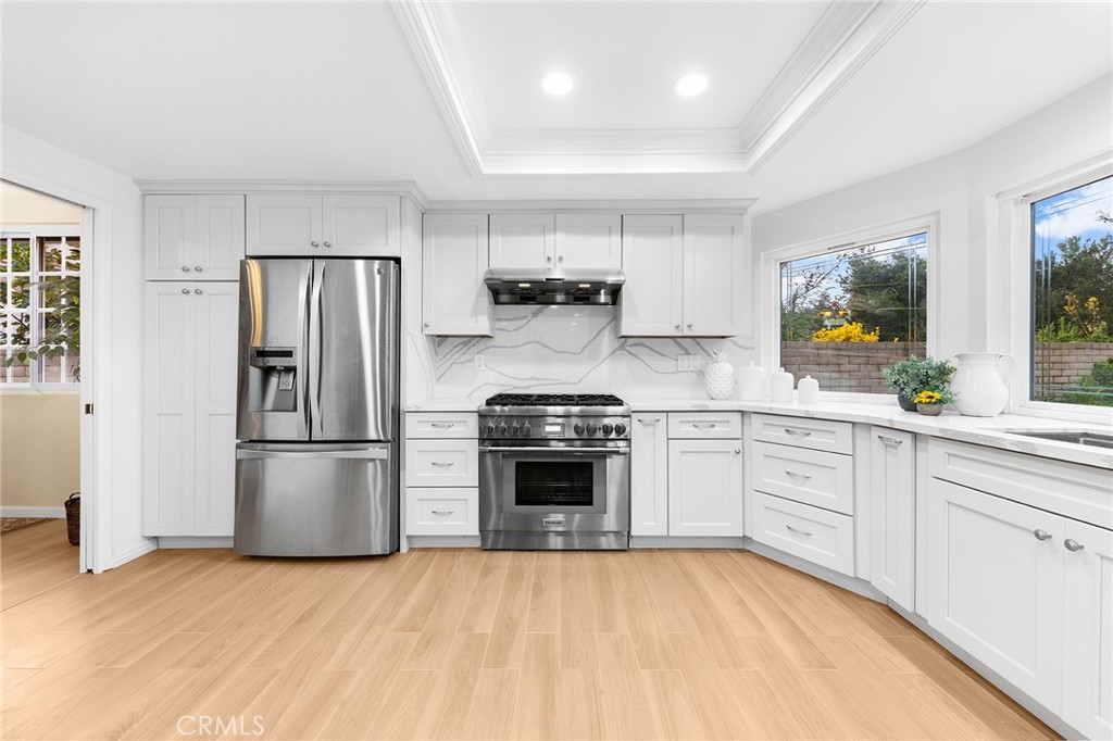 20329 Rim Ridge Road Walnut, CA 91789 - Photo 20 of 46 a kitchen with stainless steel appliances a refrigerator sink and stove