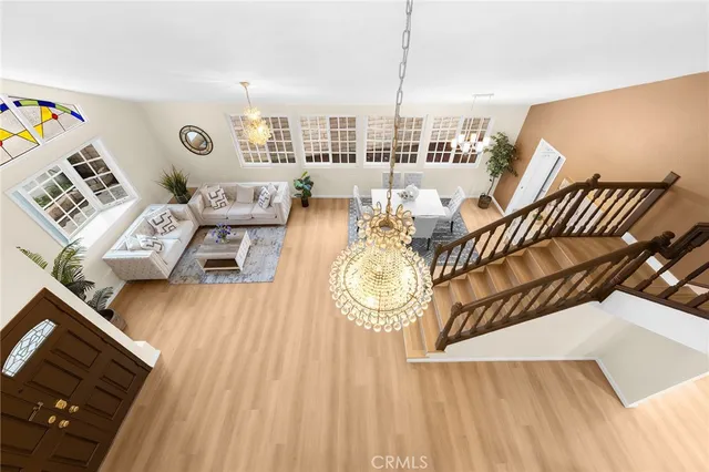 a view of a living room with furniture and wooden floor