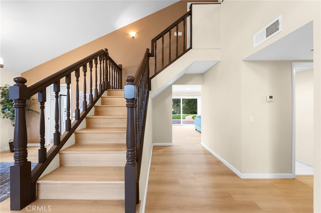 20329 Rim Ridge Road Walnut, CA 91789 - Photo 29 of 46 a view of staircase with lots of frames on wall and a potted plant