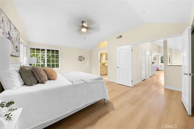 a bedroom with a large bed and a chandelier