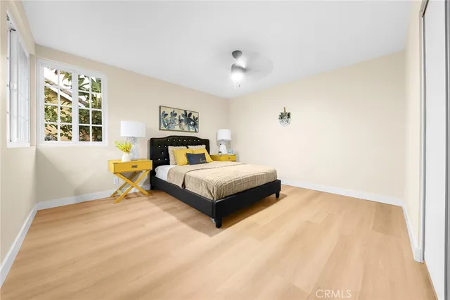 a bedroom with a bed and wooden floor