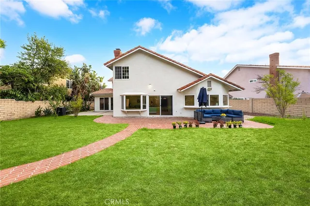 a view of a house with a yard porch and sitting area