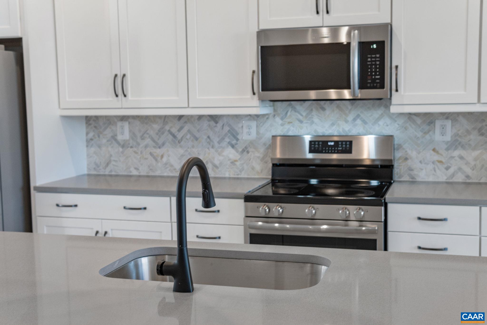 107 Park Ridge Drive Crozet, VA 22932 - Photo 11 of 42 a kitchen with microwave a stove and cabinets