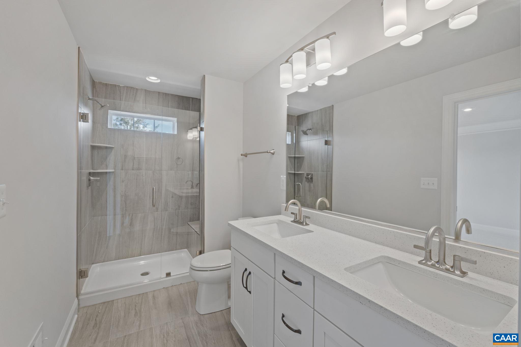 107 Park Ridge Drive Crozet, VA 22932 - Photo 30 of 42 a bathroom with a double vanity sink toilet and shower