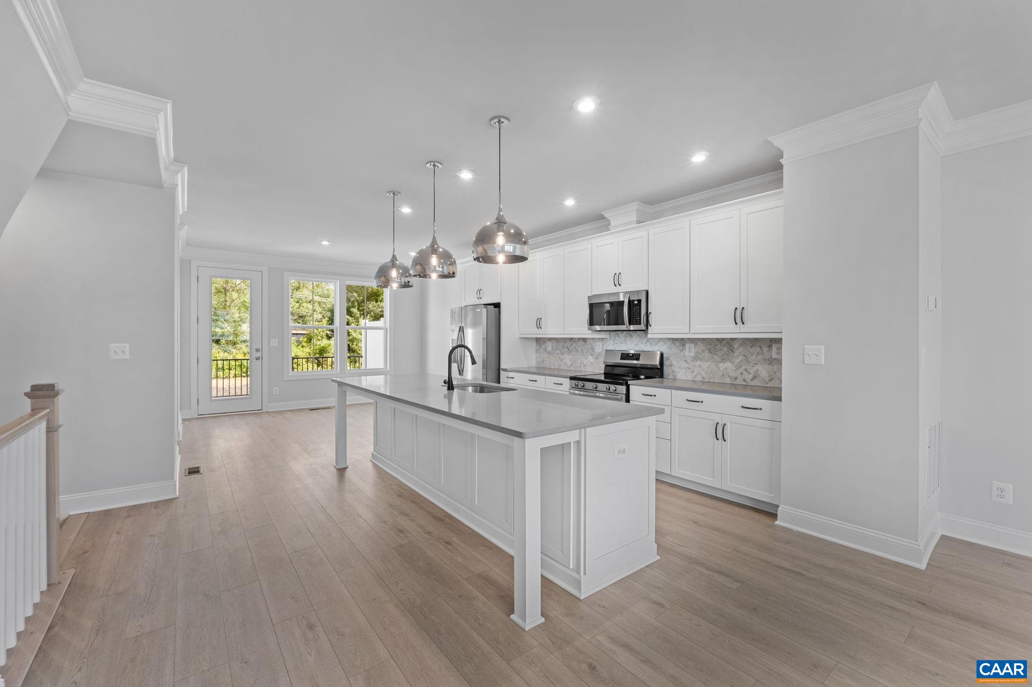 107 Park Ridge Drive Crozet, VA 22932 - Photo 10 of 42 a kitchen with kitchen island granite countertop a sink cabinets and wooden floor