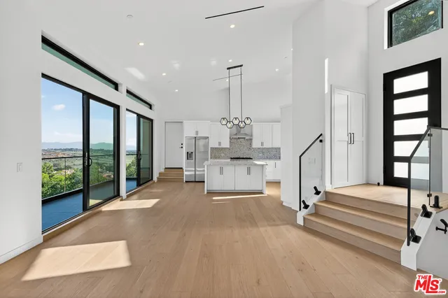 a view of front door with hallway and stairs