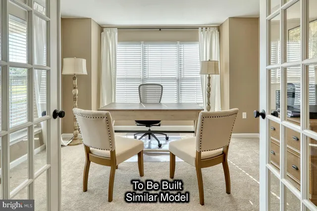 a view of a dining room with furniture and a window