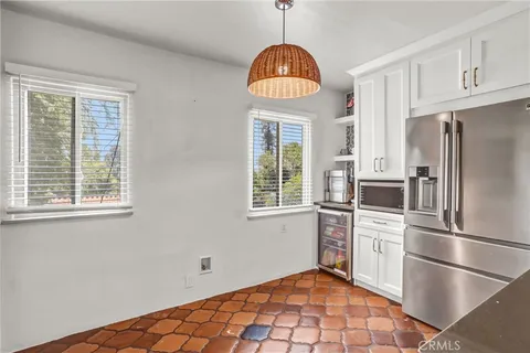 a kitchen with center island table and chairs