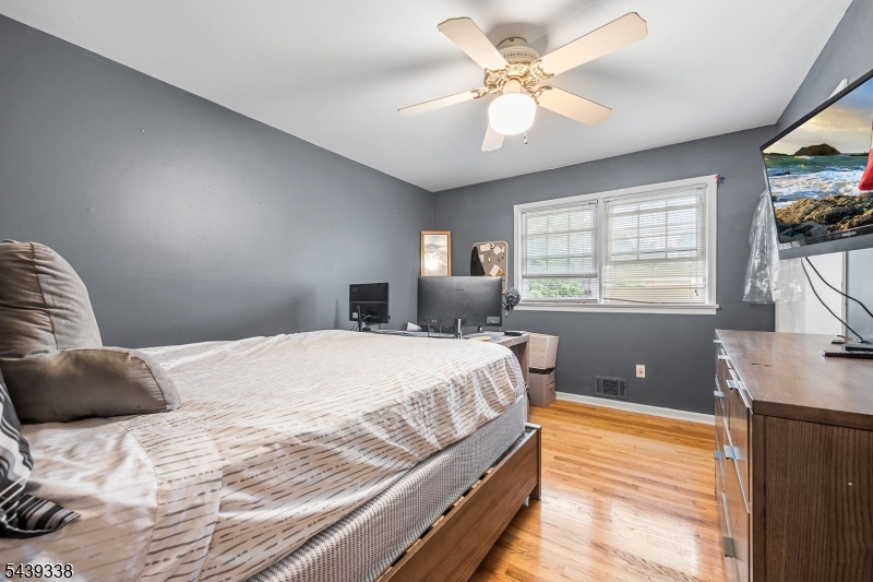 1 Oak Grove Road Flemington, NJ 08822 - Photo 18 of 29 a bedroom with a large bed and a chandelier