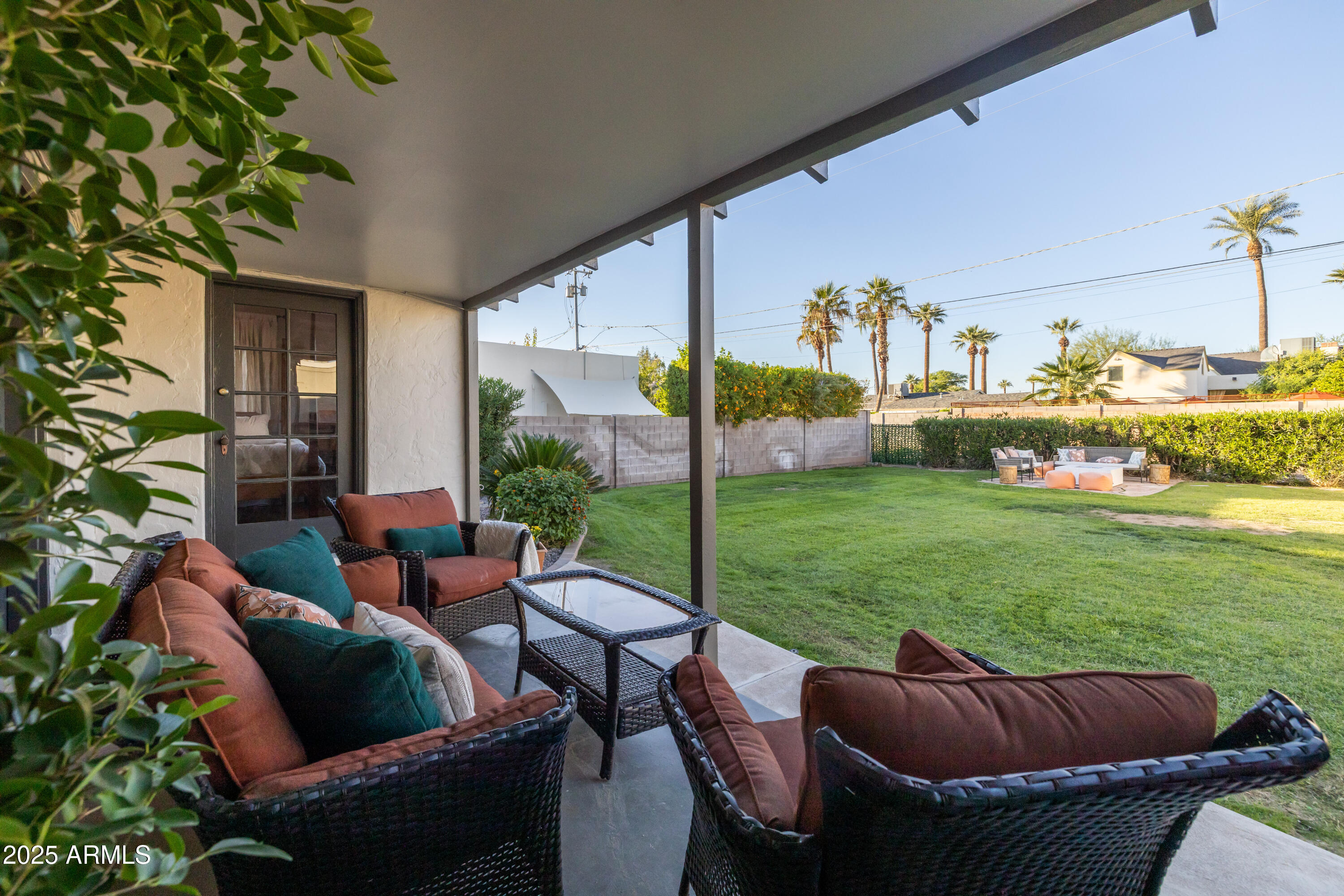 126 West Coronado Road Phoenix, AZ 85003 - Photo 48 of 60 a view of a patio with couches chairs potted plants and a big yard