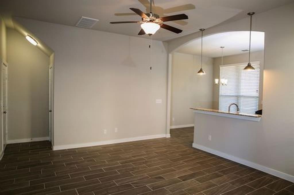 117 Calm Water Loop Bastrop, TX 78602 - Photo 4 of 7 a view of a kitchen with a sink and a refrigerator