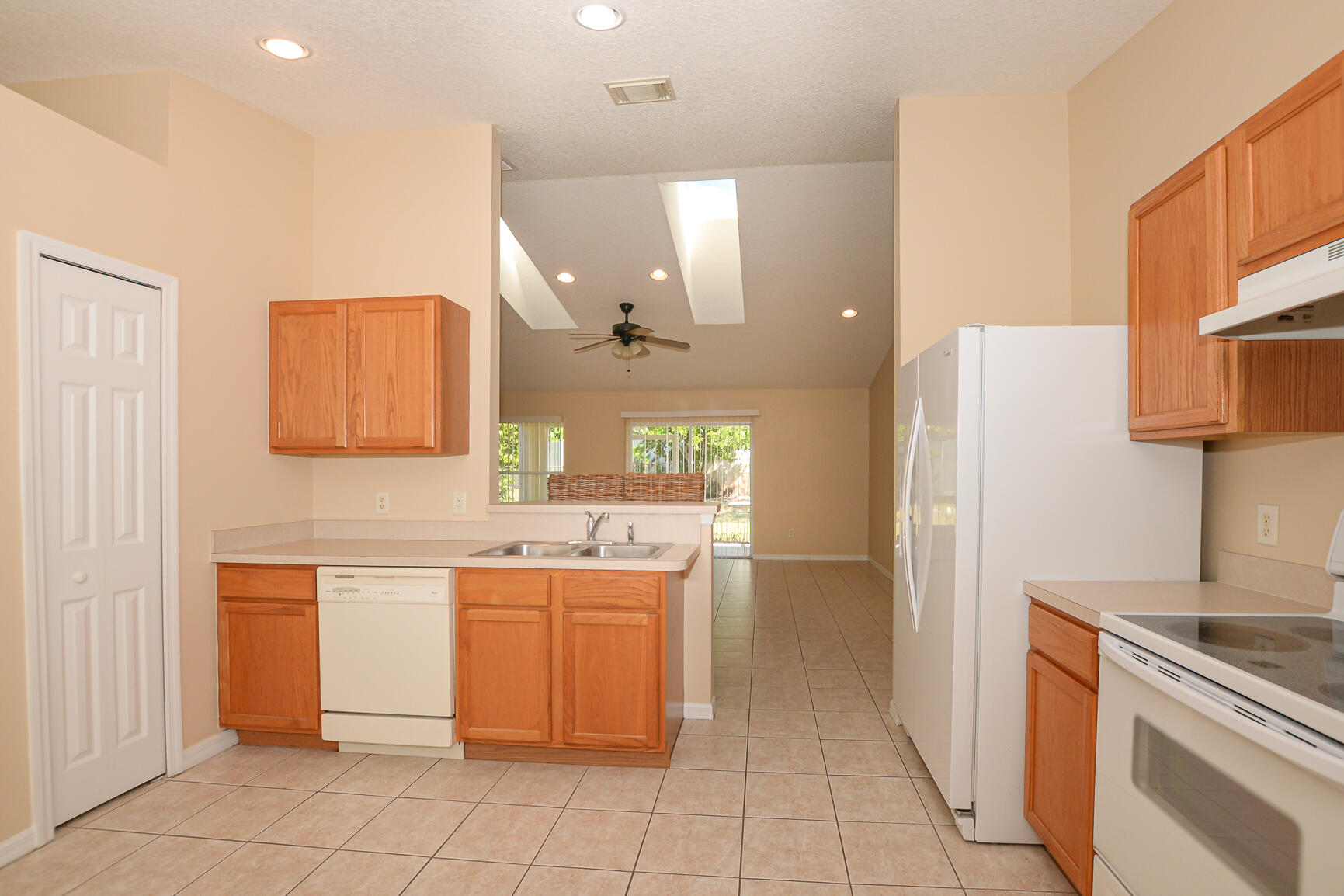 2201 Southeast Carnation Road Port St. Lucie, FL 34952 - Photo 12 of 37 a kitchen with a sink and cabinets