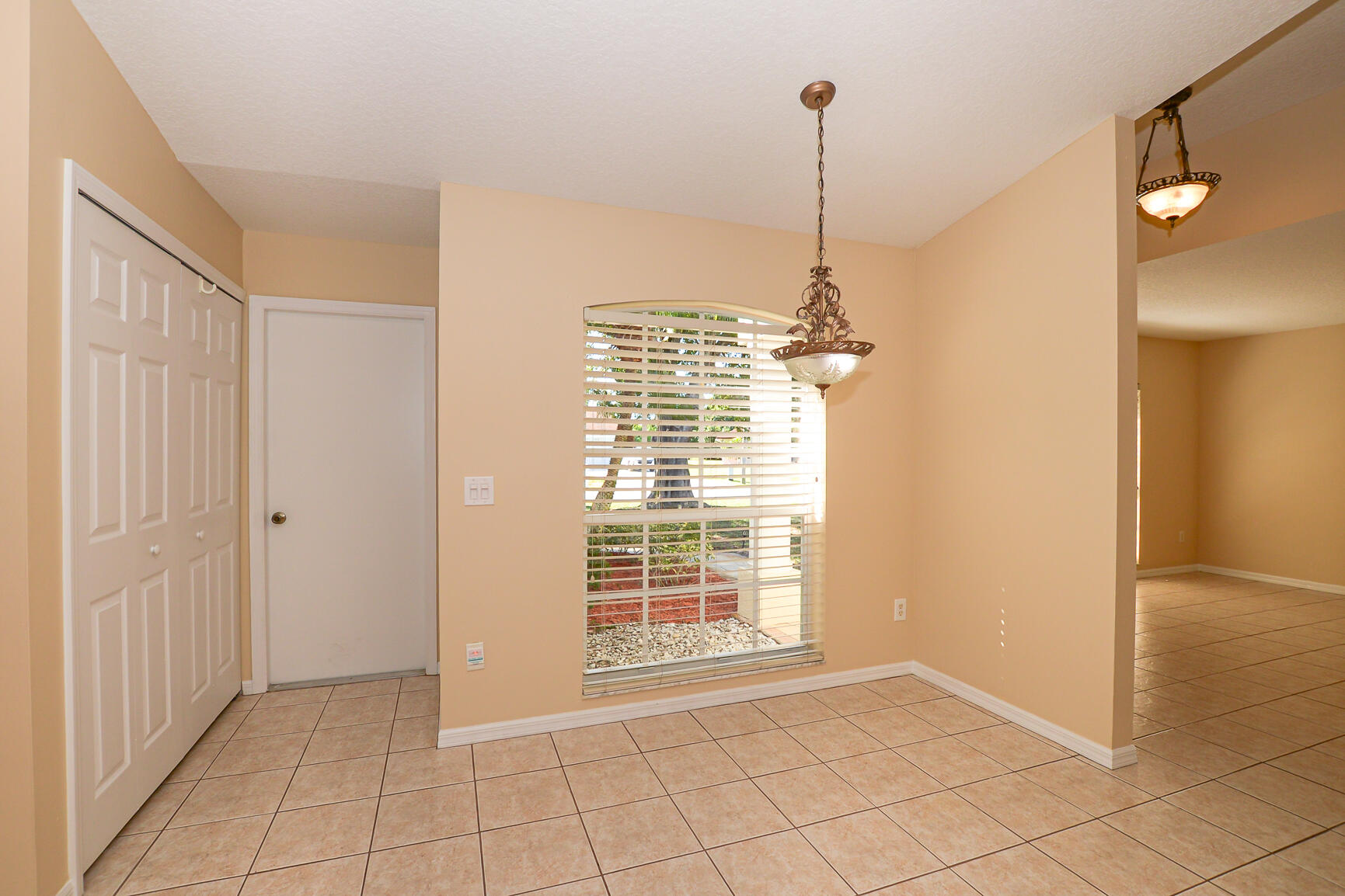 2201 Southeast Carnation Road Port St. Lucie, FL 34952 - Photo 13 of 37 a view of an empty room with windows