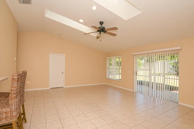 a view of a livingroom with a ceiling fan and window