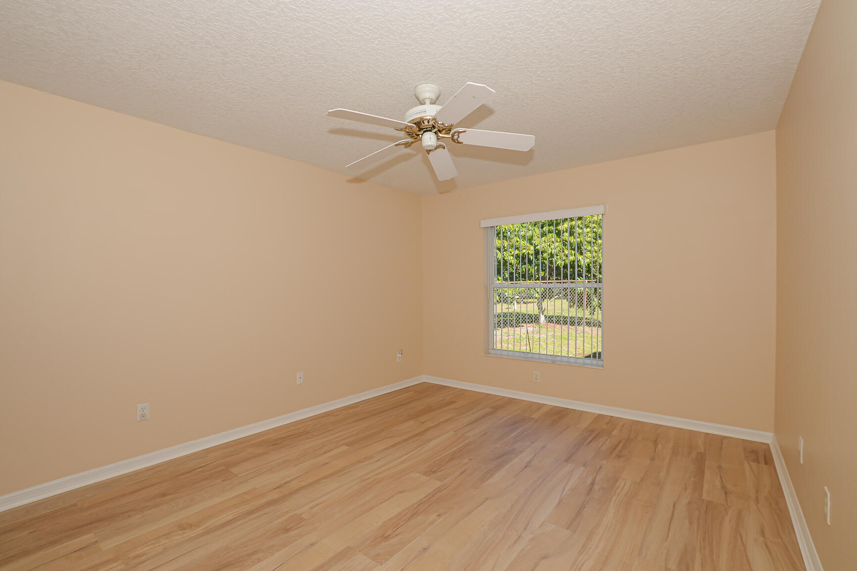 2201 Southeast Carnation Road Port St. Lucie, FL 34952 - Photo 18 of 37 an empty room with a window and a fan