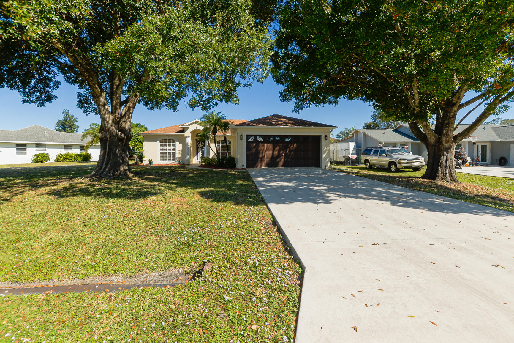 2201 Southeast Carnation Road Port St. Lucie, FL 34952 - Photo 2 of 37 a front view of a house with a yard