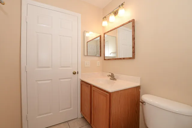 a bathroom with a sink a toilet and mirror