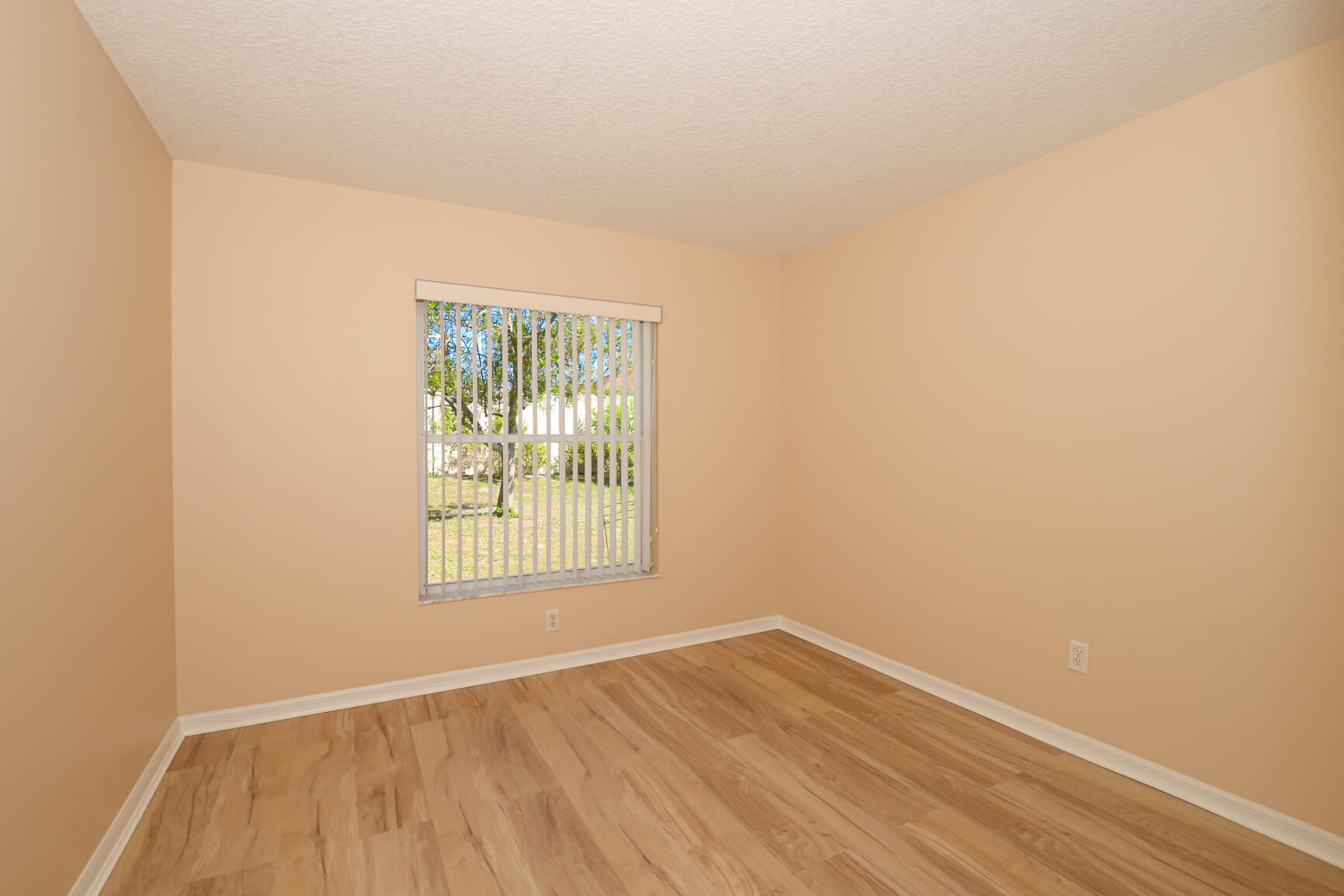 2201 Southeast Carnation Road Port St. Lucie, FL 34952 - Photo 23 of 37 an empty room with wooden floor and windows