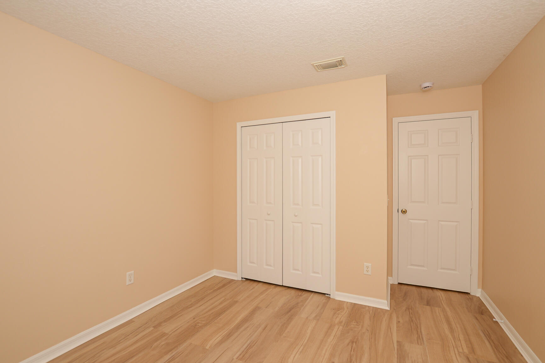 2201 Southeast Carnation Road Port St. Lucie, FL 34952 - Photo 24 of 37 a view of an empty room with wooden floor