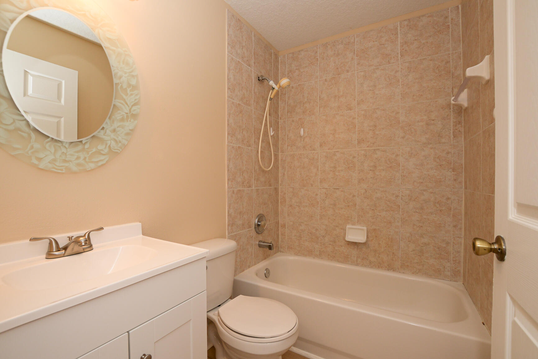 2201 Southeast Carnation Road Port St. Lucie, FL 34952 - Photo 25 of 37 a bathroom with a granite countertop sink mirror toilet and bathtub