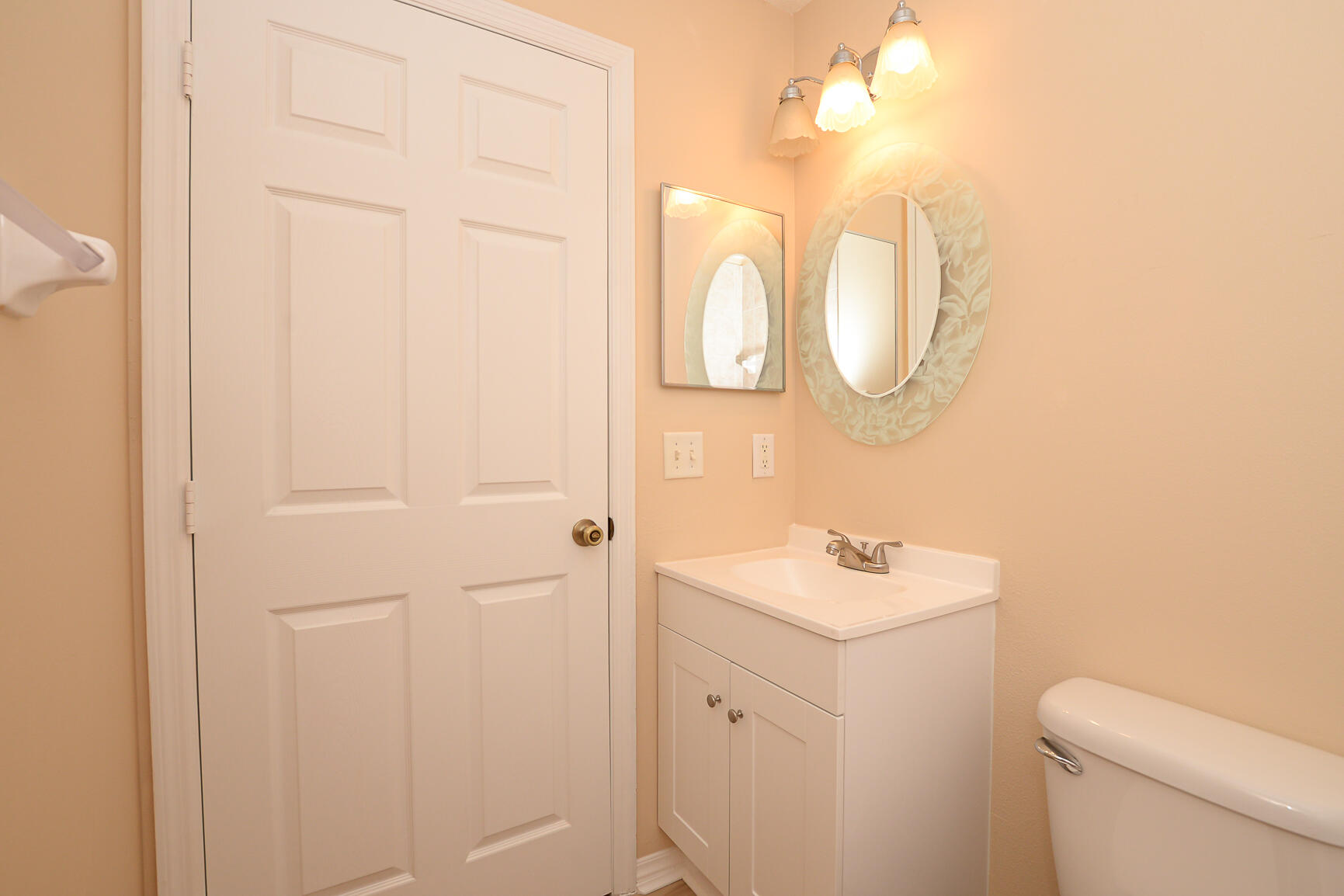 2201 Southeast Carnation Road Port St. Lucie, FL 34952 - Photo 26 of 37 a bathroom with a sink and mirror with toilet
