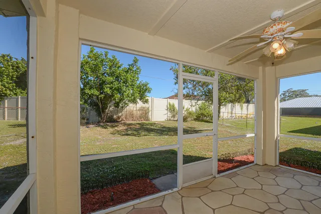 a view of a porch with a table and chairs