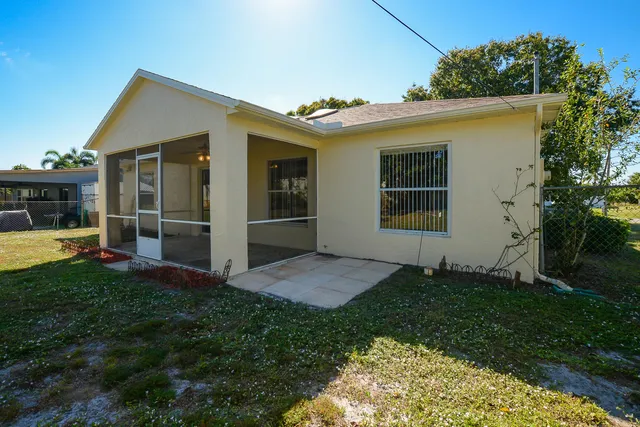 a view of an house with backyard space and garden