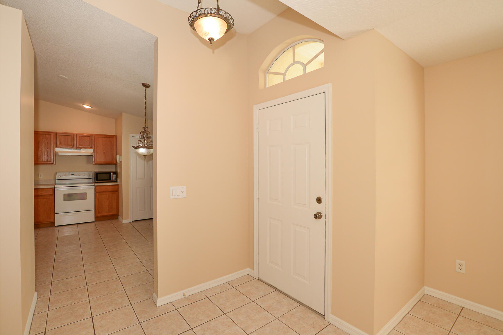 2201 Southeast Carnation Road Port St. Lucie, FL 34952 - Photo 7 of 37 a view of a kitchen from the hallway