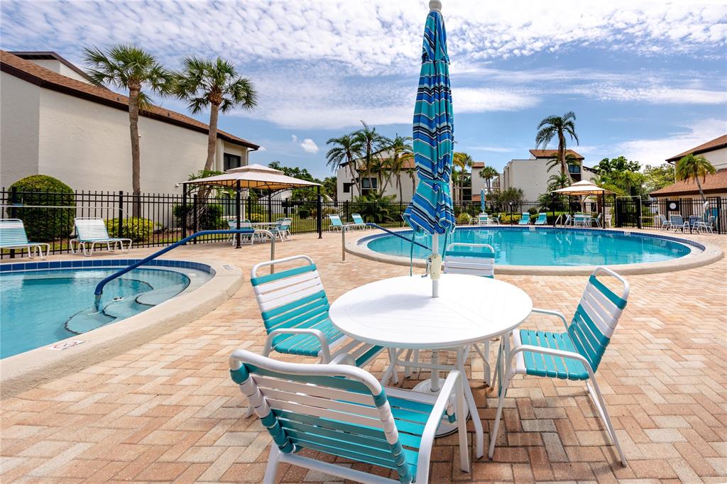 2207 Belleair Road, Unit B30 Clearwater, FL 33764 - Photo 32 of 39 a view of a swimming pool with a patio and a yard