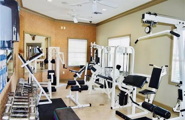 a view of a livingroom with furniture and gym equipment