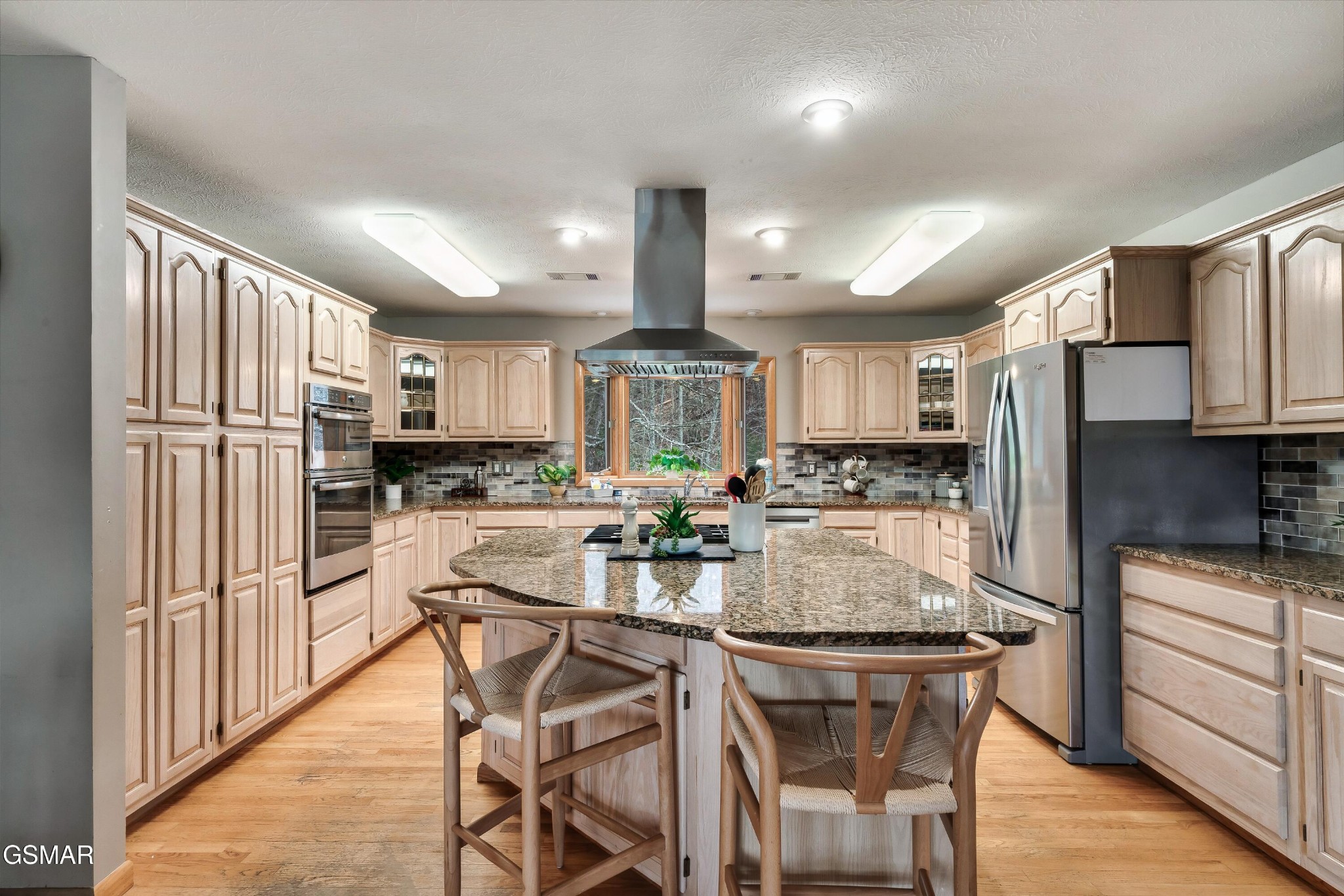 4062 Wilhite Road Sevierville, TN 37876 - Photo 14 of 50 a kitchen with stainless steel appliances kitchen island granite countertop a refrigerator and a stove top oven