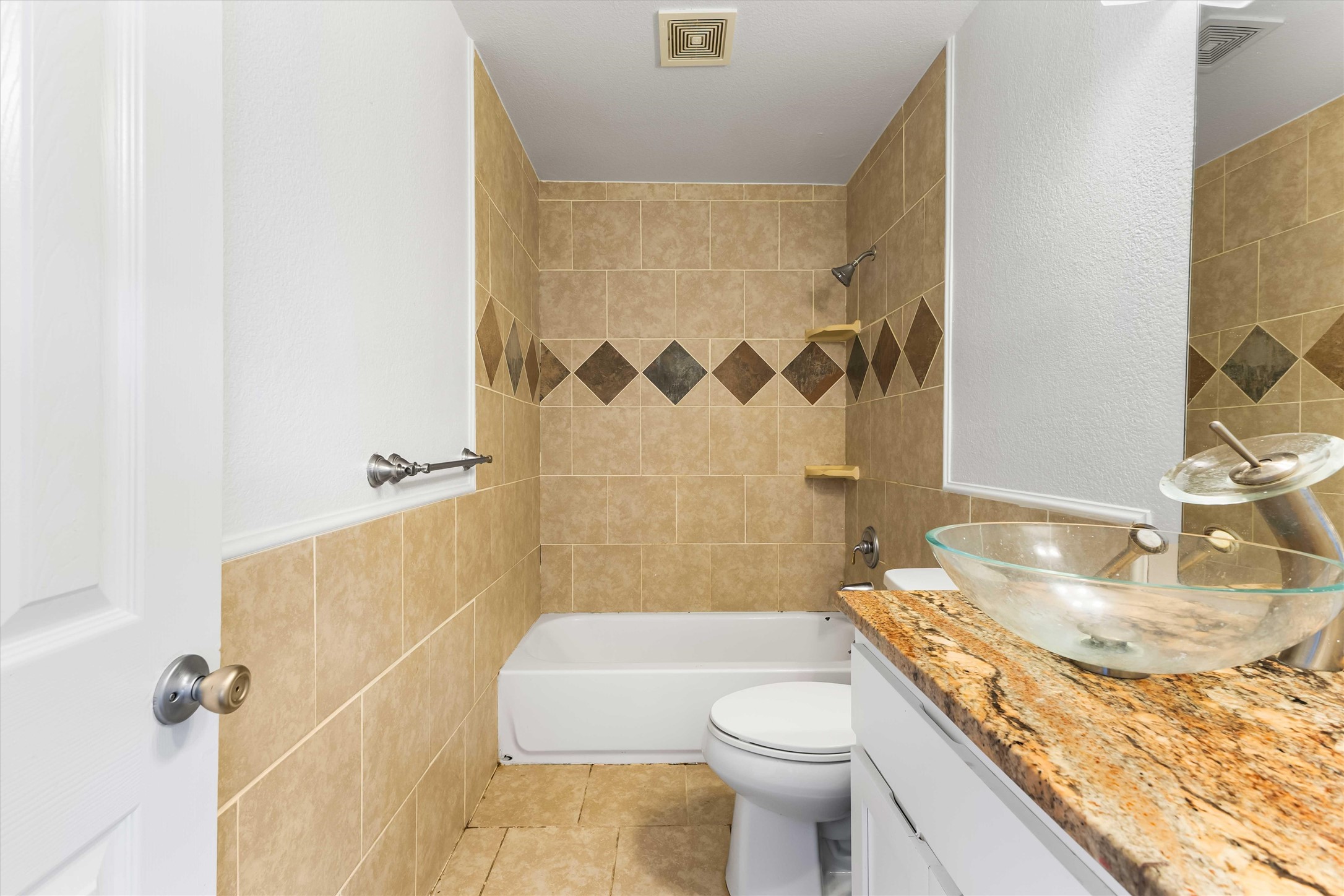 12212 Ballerstedt Road Elgin, TX 78621 - Photo 26 of 39 Full bathroom featuring bathing tub / shower combination, tile walls, vanity, a textured wall, and light tile patterned floors