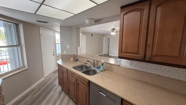 a kitchen with a sink and a refrigerator