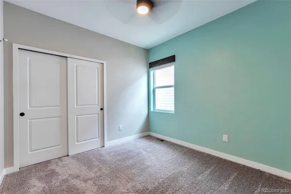 an empty room with windows and closet
