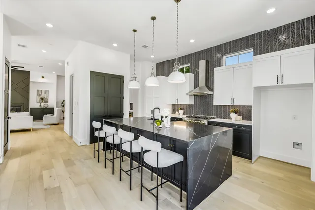 a kitchen with a sink stove and cabinets