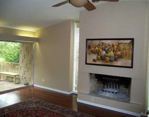a view of a hallway with wooden floor and a fireplace