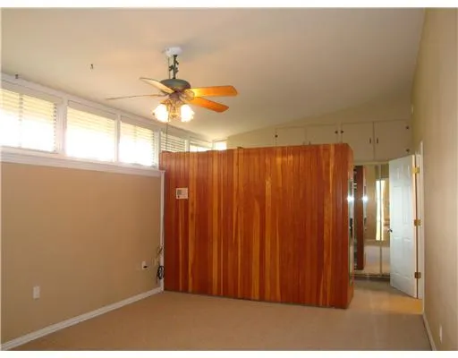 a view of a livingroom with a ceiling fan and window