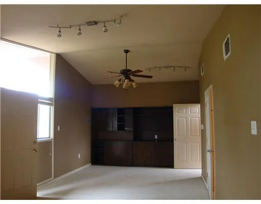 a view of a livingroom with a ceiling fan and closet
