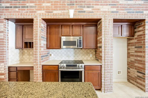 a kitchen with stainless steel appliances granite countertop a stove and a sink