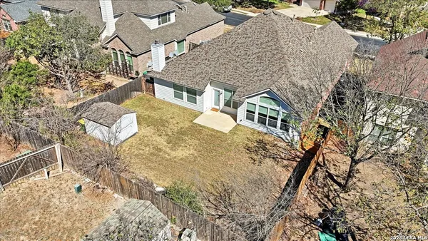an aerial view of residential houses with yard