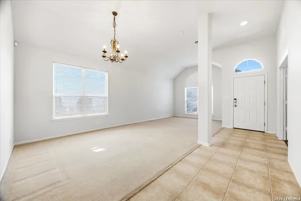 an empty room with windows and cabinet