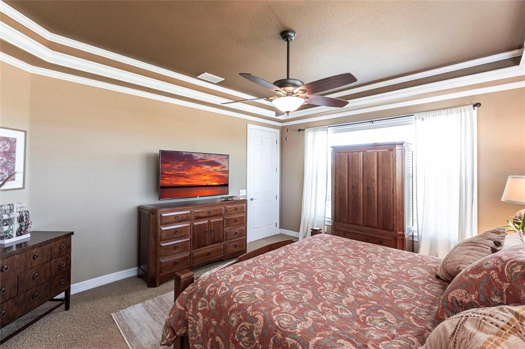 3712 Balboa Court Punta Gorda, FL 33983 - Photo 11 of 53 a bedroom with a bed and a chandelier