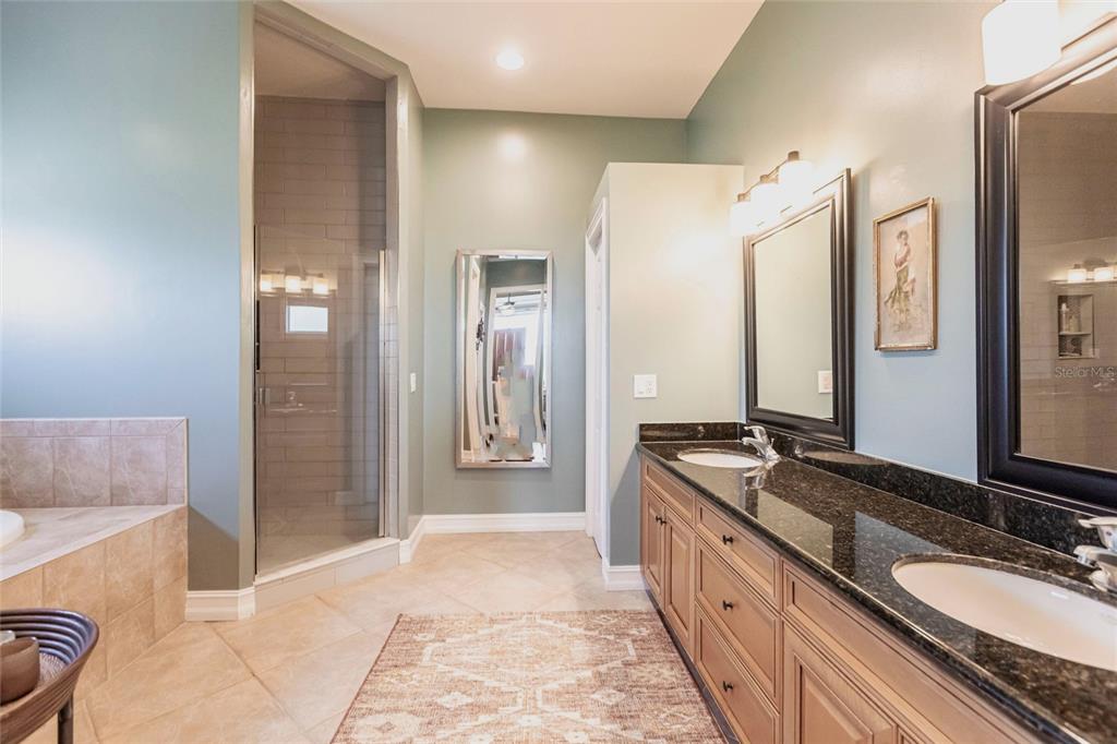 3712 Balboa Court Punta Gorda, FL 33983 - Photo 12 of 53 a spacious bathroom with a granite countertop double vanity sink a mirror and a shower